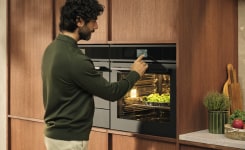 Woman opens oven door