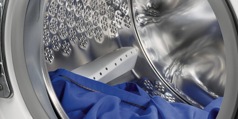 Schéma démontrant l'espace à laisser entre vos vêtements et le plafond du tambour.